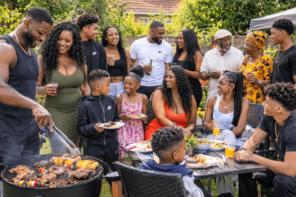 A multigenerational family enjoying a garden barbecue together